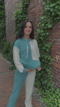 Load and play video in Gallery viewer, Rise and slay in this cute jogger set!  The oversized top Features a draw-string hood, front pocket. The pants have an elastic waist with an added drawstring for the perfect fit and side pockets made especially for your Insta-poses.  The great colors are Sage green and Beige.  Pair this with your trendy dad-style sneakers or your favorite slippers.   60% Cotton 40% Polyester  Available in sizes Small, Medium, and Large Oversized top Elastic waist with drawstring
