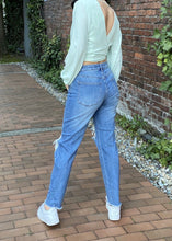 Load image into Gallery viewer, “Where are my good jeans?” Right here, girl! These jeans are the perfect go-to pair. Featuring a five-button closure for a perfect and secure fit along with ripped detailing and distressed hem. The straight cut bottom and mid-rise waist pair great with booties and a fun top.   99% cotton 1% spandex Available in size 3-13 five-button front closure
