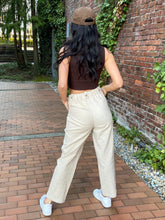 Load image into Gallery viewer, High Waisted Draw String  Linen-Look Pants igh elastic and drawstring waist. Textured with lines, Pull-on with a Faux fly.  The button tabs add to the style.  Side pockets and a cropped straight leg.  Available in Blue and Tan sizes Small, Medium, and Large
