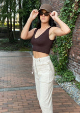 Load image into Gallery viewer, Comfy pants are the best part of any day! These pants are both cute and comfortable with a high elastic and drawstring waist. Textured with lines, Pull-on with a Faux fly.  The button tabs add to the style.  Side pockets and a cropped straight leg.  Available in Blue and Tan sizes Small, Medium, and Large  100% Linen-Look cotton Available in Blue and Tan Sizes Small, Medium, and Large High elastic drawstring waist
