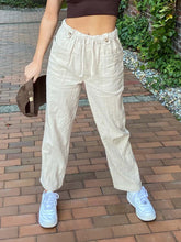 Load image into Gallery viewer, High Waisted Draw String  Linen-Look Pants igh elastic and drawstring waist. Textured with lines, Pull-on with a Faux fly.  The button tabs add to the style.  Side pockets and a cropped straight leg.  Available in Blue and Tan sizes Small, Medium, and Large
