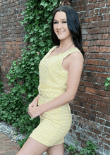 Load image into Gallery viewer, Chase your dreams and show up in class wearing this gorgeous dress! Features an eyelash V neck and a pearl-embellished buckle and buttons on the faux pockets. This luxurious dress is a beautiful yellow and white woven fabric and it&#39;s lined for added comfort.  100% woven polyester Available in sizes Small, Medium, and Large Lined Zip up 
